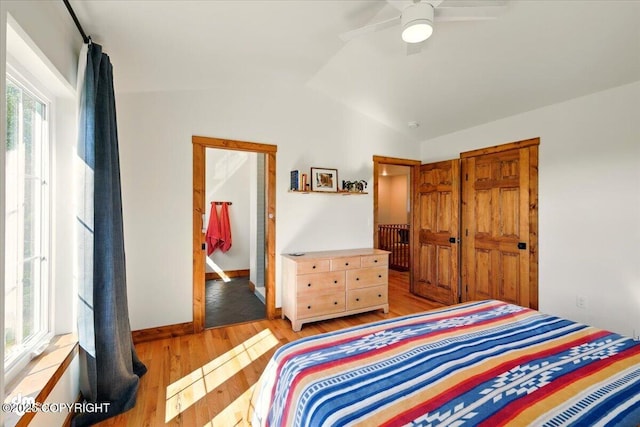 7350 E Narnia Cir, Palmer, AK 99645 - bedroom featuring lofted ceiling, light wood-type flooring, a ceiling fan, and baseboards