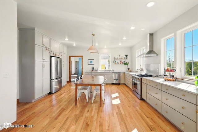 7350 E Narnia Cir, Palmer, AK 99645 - kitchen featuring wall chimney range hood, stainless steel appliances, plenty of natural light, recessed lighting, and open shelves