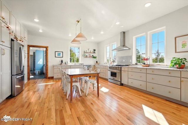 7350 E Narnia Cir, Palmer, AK 99645 - kitchen featuring wall chimney exhaust hood, stainless steel appliances, light wood finished floors, open shelves, and recessed lighting
