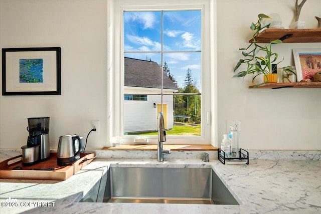 7350 E Narnia Cir, Palmer, AK 99645 - kitchen view of a sink, light stone counters, and open shelves