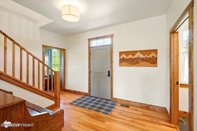 7350 E Narnia Cir, Palmer, AK 99645 - entryway with light wood-style floors, stairs, and baseboards