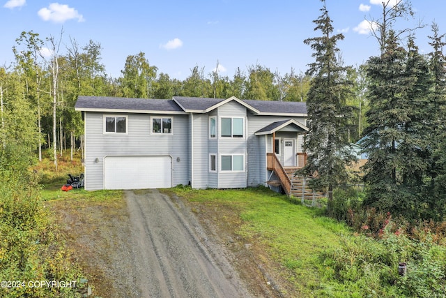 7879 W Sally Ct, Wasilla, AK 99623 - view of front facade featuring dirt driveway and an attached garage