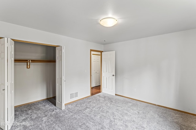 7879 W Sally Ct, Wasilla, AK 99623 - unfurnished bedroom with carpet flooring, a closet, and baseboards