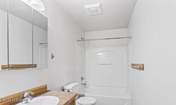 7879 W Sally Ct, Wasilla, AK 99623 - full bath featuring vanity, toilet, and shower / washtub combination