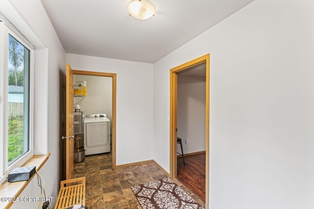 7879 W Sally Ct, Wasilla, AK 99623 - hall featuring stone finish flooring, baseboards, and washer and clothes dryer