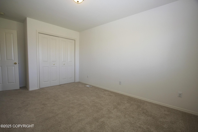 1932 Casey Cusack Loop, Anchorage, AK 99515 - unfurnished bedroom featuring carpet floors, a closet, and baseboards