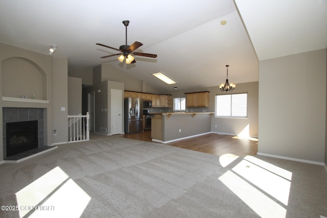 1932 Casey Cusack Loop, Anchorage, AK 99515 - unfurnished living room featuring carpet floors, a ceiling fan, a chandelier, vaulted ceiling, and baseboards