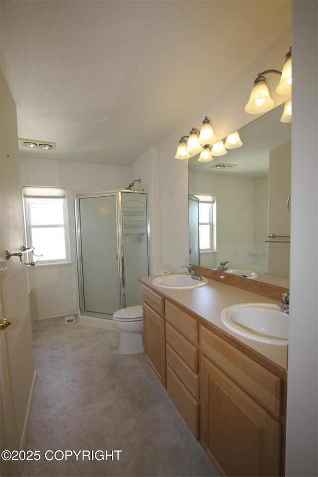 1932 Casey Cusack Loop, Anchorage, AK 99515 - bathroom featuring toilet, a stall shower, and double vanity