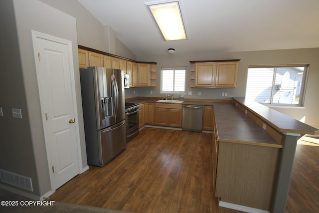 1932 Casey Cusack Loop, Anchorage, AK 99515 - kitchen with appliances with stainless steel finishes, a sink, a peninsula, light brown cabinetry, and open shelves
