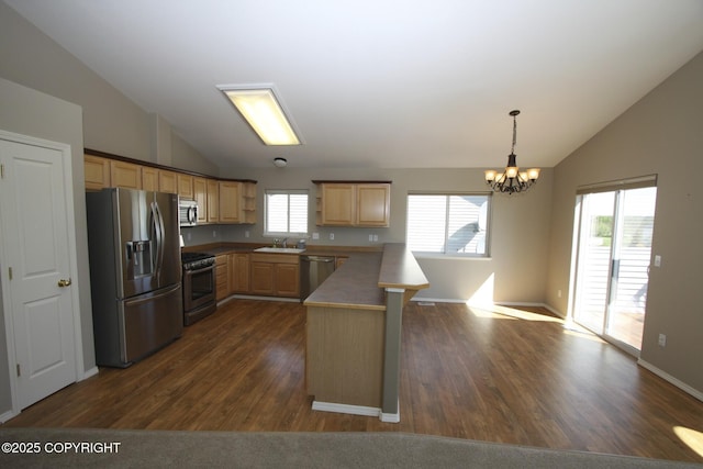 1932 Casey Cusack Loop, Anchorage, AK 99515 - kitchen featuring stainless steel appliances, vaulted ceiling, a peninsula, light brown cabinets, and a chandelier