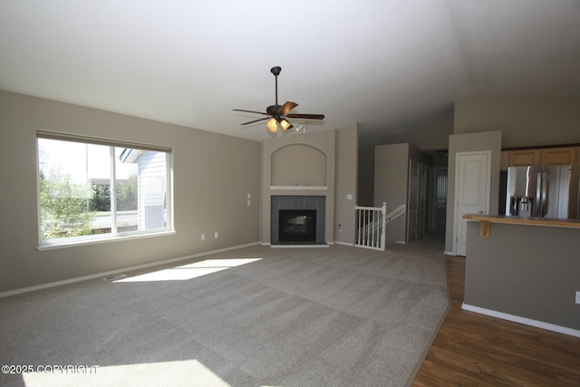 1932 Casey Cusack Loop, Anchorage, AK 99515 - unfurnished living room with vaulted ceiling, baseboards, ceiling fan, and wood finished floors