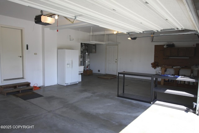 1932 Casey Cusack Loop, Anchorage, AK 99515 - garage featuring white fridge with ice dispenser and a garage door opener