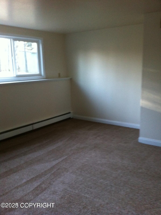 4312 Penguin St, Anchorage, AK 99503 - carpeted empty room featuring a baseboard radiator and baseboards
