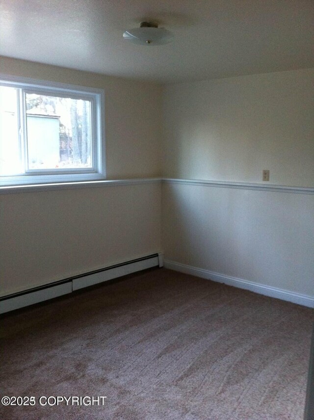 4312 Penguin St, Anchorage, AK 99503 - carpeted spare room featuring a baseboard radiator