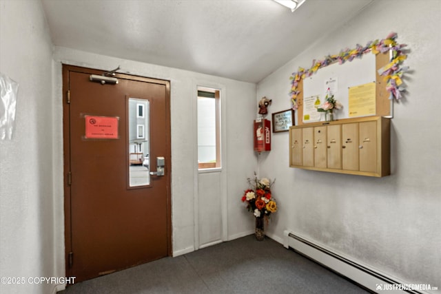 905 Wild Rose Ct # 905, Anchorage, AK 99518 - foyer entrance featuring a baseboard radiator and dark carpet