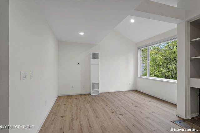 905 Wild Rose Ct # 905, Anchorage, AK 99518 - unfurnished room with wood finished floors, a heating unit, recessed lighting, baseboards, and vaulted ceiling