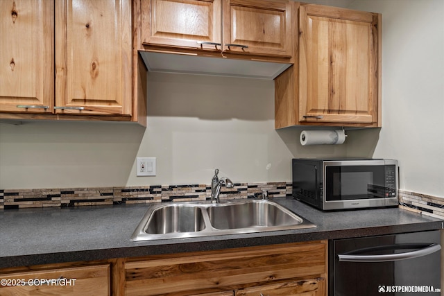 905 Wild Rose Ct # 905, Anchorage, AK 99518 - kitchen featuring appliances with stainless steel finishes, a sink, dark countertops, and backsplash