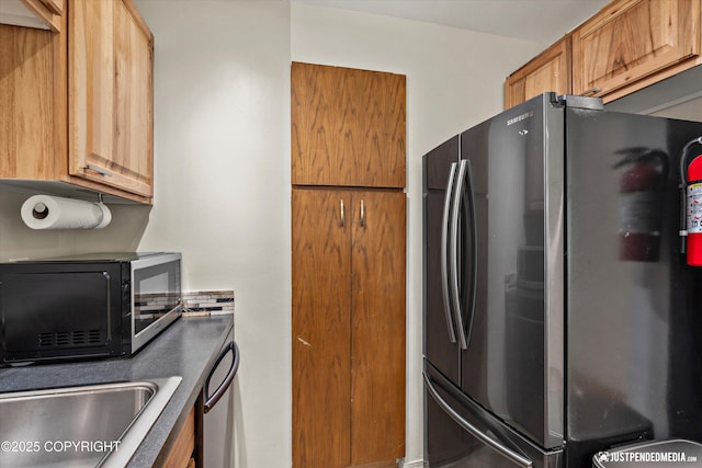 905 Wild Rose Ct # 905, Anchorage, AK 99518 - kitchen featuring freestanding refrigerator, black microwave, a sink, and stainless steel dishwasher