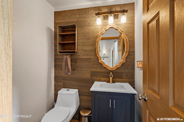 1061 E Mulchatna Dr, Wasilla, AK 99654 - bathroom featuring wood walls, toilet, and vanity