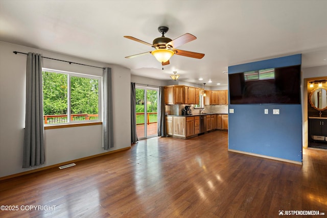 1061 E Mulchatna Dr, Wasilla, AK 99654 - kitchen featuring stainless steel dishwasher, dark wood finished floors, dark countertops, brown cabinetry, and recessed lighting