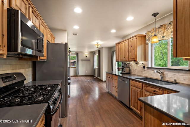 1061 E Mulchatna Dr, Wasilla, AK 99654 - kitchen featuring stainless steel appliances, a sink, dark countertops, healthy amount of natural light, and recessed lighting