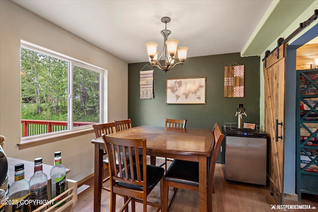 1061 E Mulchatna Dr, Wasilla, AK 99654 - dining space featuring a barn door, wood finished floors, and a chandelier
