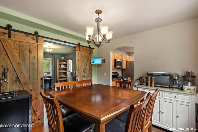 1061 E Mulchatna Dr, Wasilla, AK 99654 - dining room with a barn door, arched walkways, and a chandelier
