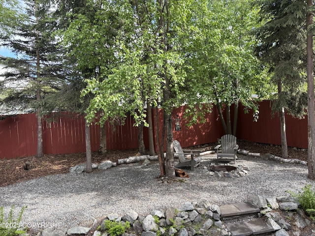 13125 W Curry Ridge Cir, Eagle River, AK 99577 - fenced yard with a fire pit
