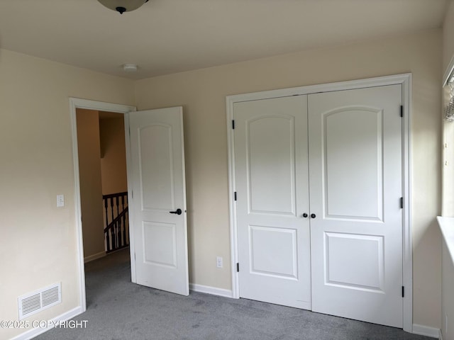 13125 W Curry Ridge Cir, Eagle River, AK 99577 - unfurnished bedroom featuring carpet flooring, a closet, and baseboards