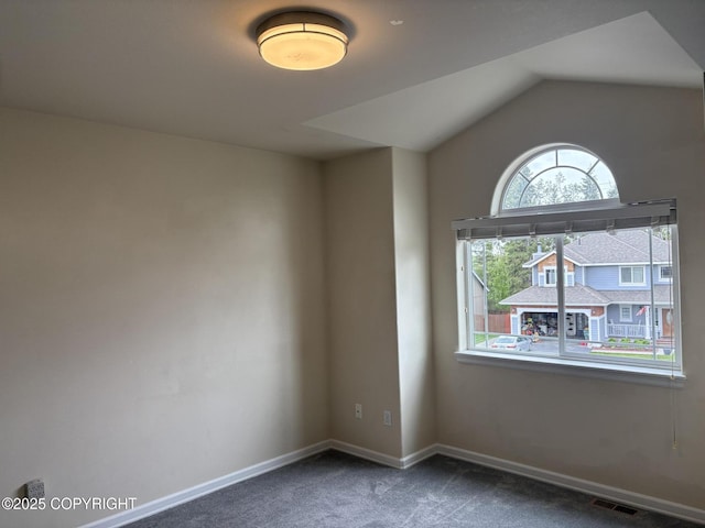 13125 W Curry Ridge Cir, Eagle River, AK 99577 - spare room featuring carpet flooring, baseboards, and lofted ceiling