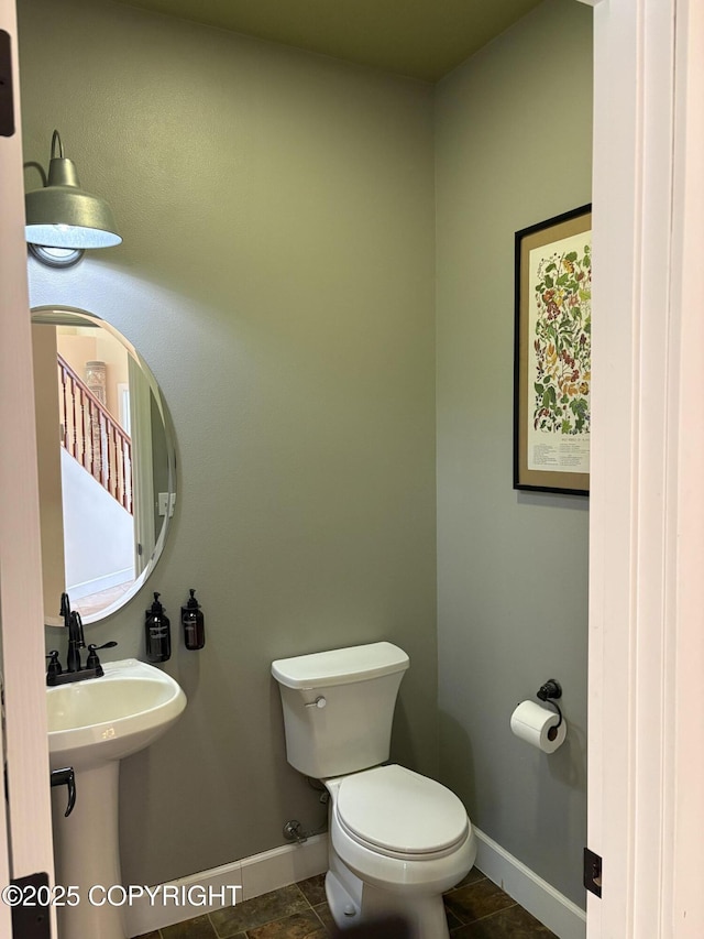 13125 W Curry Ridge Cir, Eagle River, AK 99577 - half bath featuring toilet, baseboards, tile patterned floors, and a sink