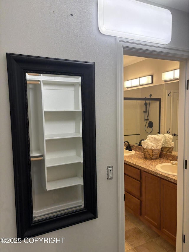 13125 W Curry Ridge Cir, Eagle River, AK 99577 - full bathroom with double vanity, a shower stall, and tile patterned floors