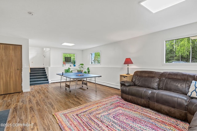 45035 Ptarmigan Pl, Soldotna, AK 99669 - living area featuring wood finished floors, stairway, and baseboard heating
