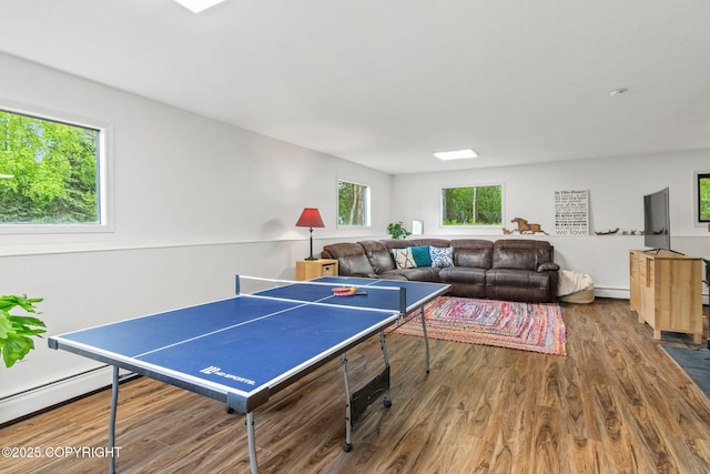 45035 Ptarmigan Pl, Soldotna, AK 99669 - game room featuring wood finished floors, a baseboard radiator, and baseboard heating