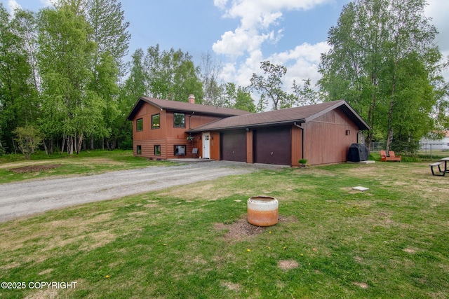 45035 Ptarmigan Pl, Soldotna, AK 99669 - view of front of property with dirt driveway, a chimney, and a garage