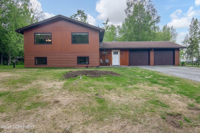 45035 Ptarmigan Pl, Soldotna, AK 99669 - tri-level home featuring a garage, gravel driveway, and a front yard