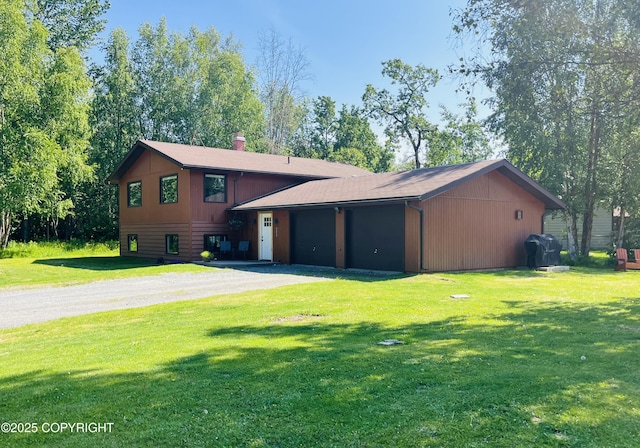 45035 Ptarmigan Pl, Soldotna, AK 99669 - view of front of property featuring dirt driveway, a front lawn, and a garage