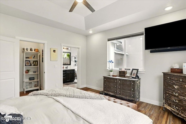 8727 Turlock Dr, Eagle River, AK 99577 - bedroom featuring wood finished floors, baseboards, a raised ceiling, ensuite bath, and recessed lighting