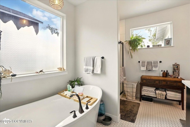 8727 Turlock Dr, Eagle River, AK 99577 - full bathroom with a shower, a freestanding bath, and baseboards