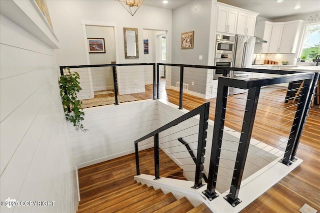 8727 Turlock Dr, Eagle River, AK 99577 - stairway with wood finished floors, recessed lighting, and baseboards