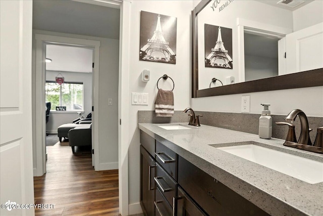 8727 Turlock Dr, Eagle River, AK 99577 - full bathroom with double vanity, wood finished floors, and baseboards