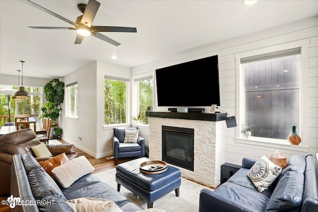 8727 Turlock Dr, Eagle River, AK 99577 - living room featuring wood finished floors, baseboards, ceiling fan, a stone fireplace, and recessed lighting