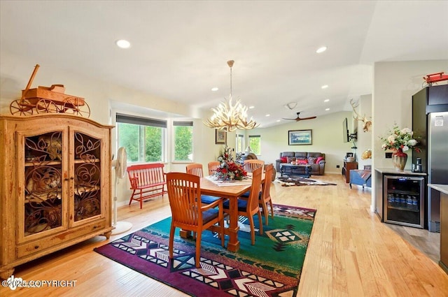 3872 N Charley Dr, Wasilla, AK 99654 - dining space with beverage cooler, light wood-style floors, vaulted ceiling, a chandelier, and recessed lighting