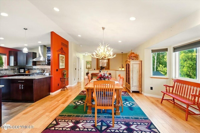 3872 N Charley Dr, Wasilla, AK 99654 - dining area featuring light wood-style flooring, a chandelier, baseboards, and recessed lighting