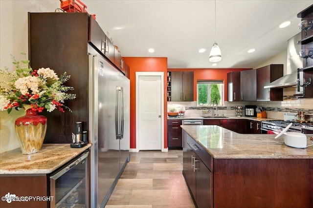 3872 N Charley Dr, Wasilla, AK 99654 - kitchen featuring stainless steel fridge, beverage cooler, stove, backsplash, and a sink