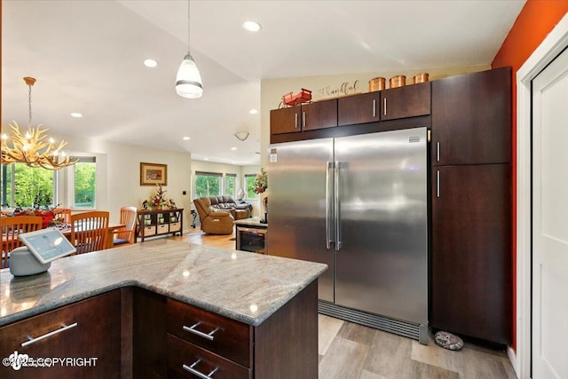 3872 N Charley Dr, Wasilla, AK 99654 - kitchen featuring built in refrigerator, light wood-style floors, plenty of natural light, hanging light fixtures, and recessed lighting