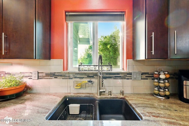3872 N Charley Dr, Wasilla, AK 99654 - kitchen with a sink, backsplash, light stone countertops, and healthy amount of natural light