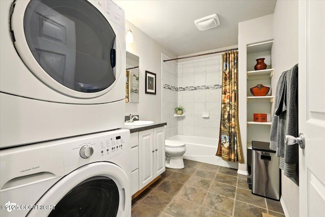 3872 N Charley Dr, Wasilla, AK 99654 - full bath featuring estacked washer and dryer, toilet, shower / tub combo with curtain, vanity, and stone finish flooring