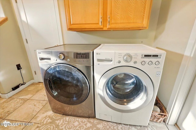 3872 N Charley Dr, Wasilla, AK 99654 - washroom featuring cabinet space, separate washer and dryer, and light tile patterned floors