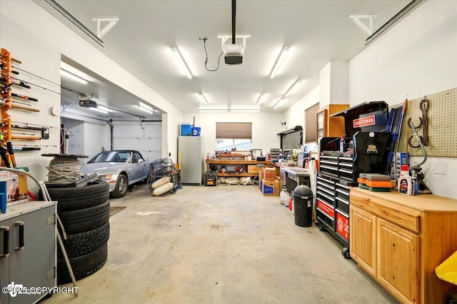 3872 N Charley Dr, Wasilla, AK 99654 - garage with a garage door opener, a workshop area, and freestanding refrigerator